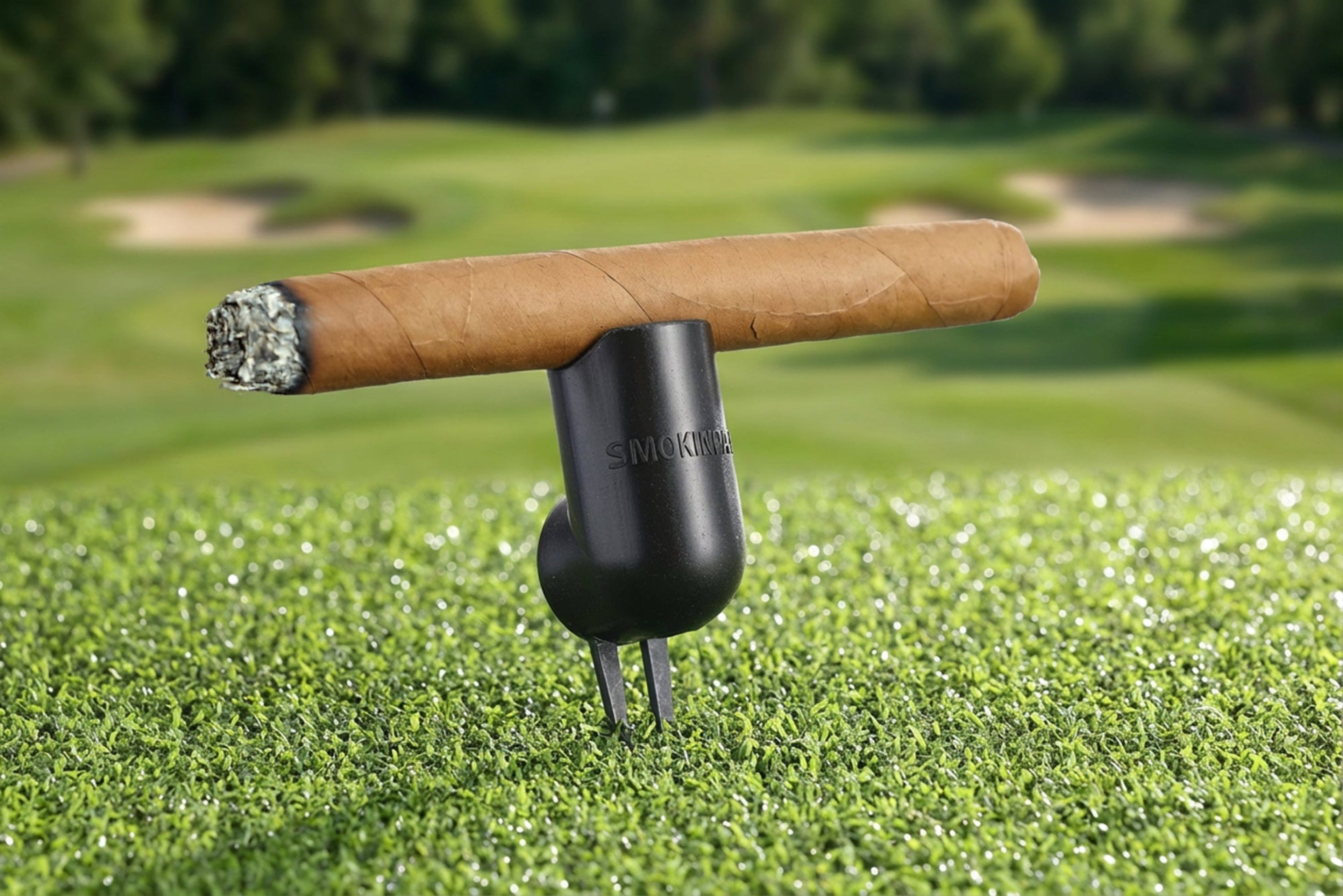 Cigar on a holder with a golf course background